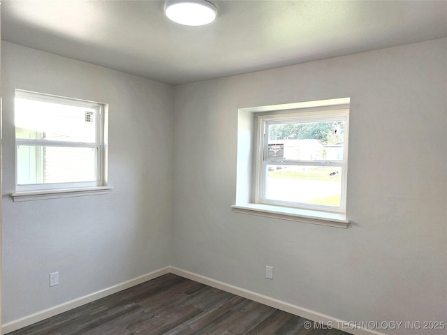 12623 E 19th St, Tulsa, OK 74128 - spare room with baseboards and dark wood-style flooring