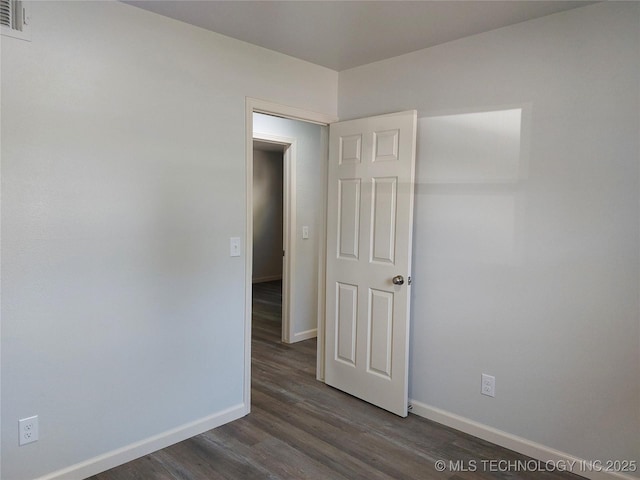 12623 E 19th St, Tulsa, OK 74128 - unfurnished room featuring baseboards and dark wood-type flooring