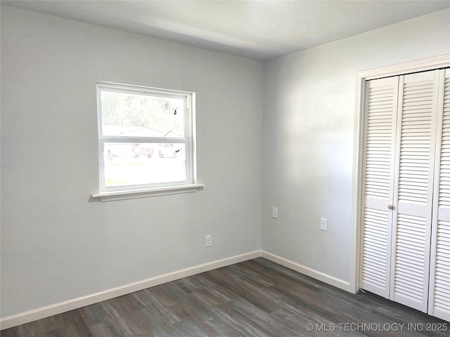 12623 E 19th St, Tulsa, OK 74128 - unfurnished bedroom featuring dark wood-style flooring and a closet