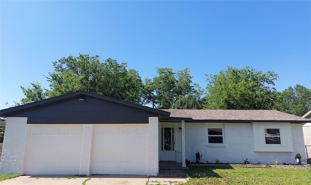 12623 E 19th St, Tulsa, OK 74128 - ranch-style home featuring brick siding, concrete driveway, a garage, and a shingled roof