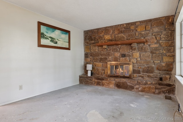 905 W Andrew Ave, Sapulpa, OK 74066 - unfurnished living room featuring a stone fireplace and concrete flooring