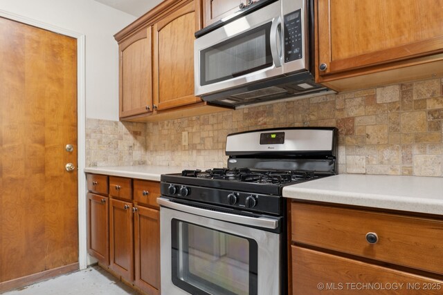 905 W Andrew Ave, Sapulpa, OK 74066 - kitchen with appliances with stainless steel finishes, brown cabinetry, backsplash, and light countertops