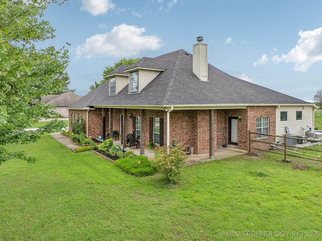 11902 N 150th E Ave, Collinsville, OK 74021 - back of house with brick siding, a chimney, a shingled roof, and a patio area