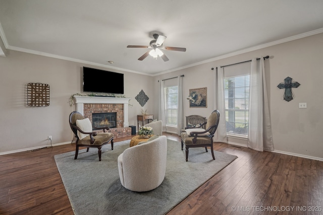 11902 N 150th E Ave, Collinsville, OK 74021 - living room featuring ceiling fan, dark wood-style flooring, ornamental molding, and a brick fireplace
