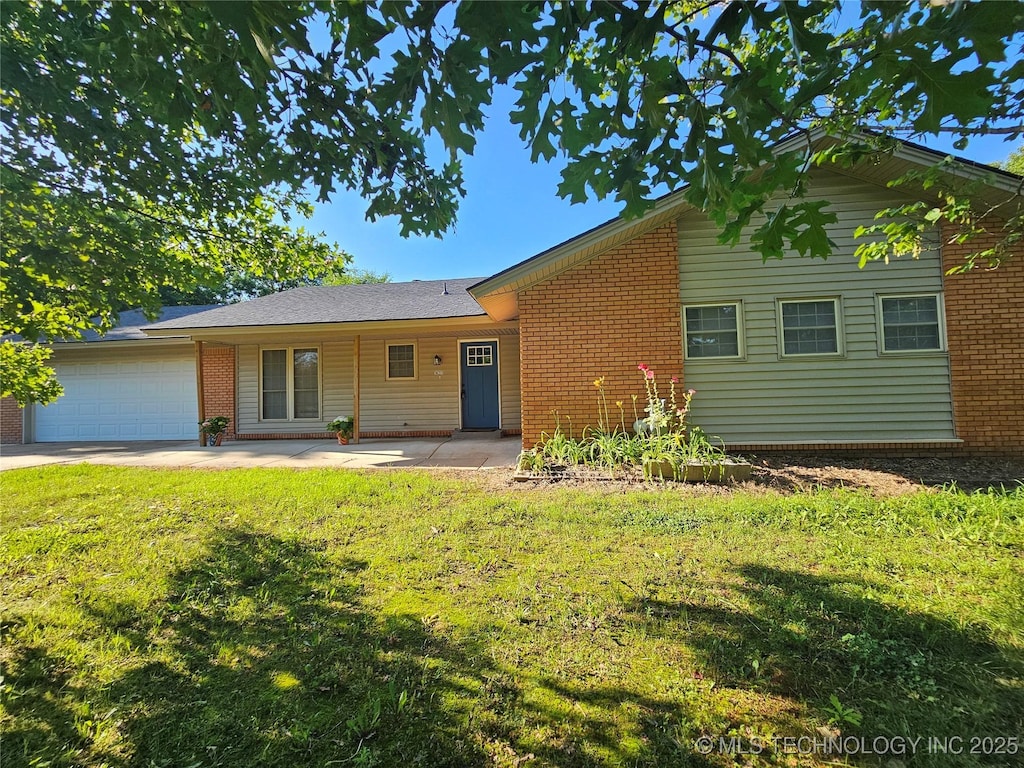 16211 E 109th St N, Owasso, OK 74055 - view of front facade with a garage, a front lawn, and brick siding