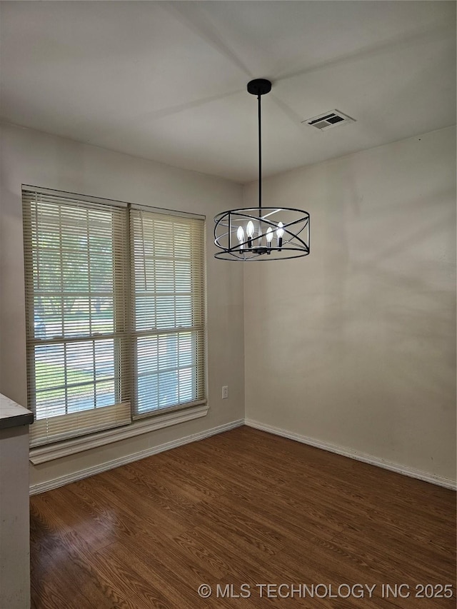16211 E 109th St N, Owasso, OK 74055 - unfurnished dining area featuring wood finished floors and a chandelier
