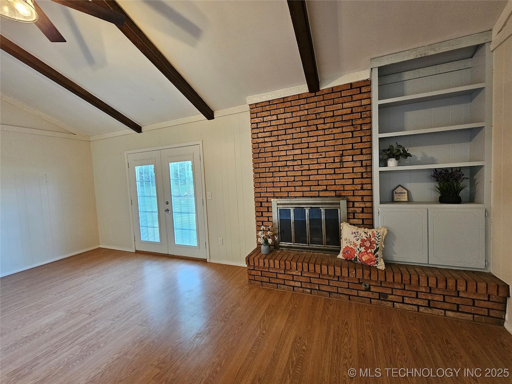16211 E 109th St N, Owasso, OK 74055 - unfurnished living room featuring wood finished floors, ceiling fan, a brick fireplace, french doors, and built in features