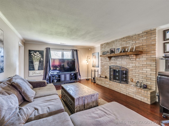 1304 W Kent St, Broken Arrow, OK 74012 - living room with wood finished floors, a fireplace, ornamental molding, and a textured ceiling