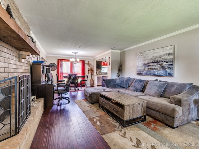 1304 W Kent St, Broken Arrow, OK 74012 - living area featuring ornamental molding, a chandelier, hardwood / wood-style floors, a textured ceiling, and a brick fireplace