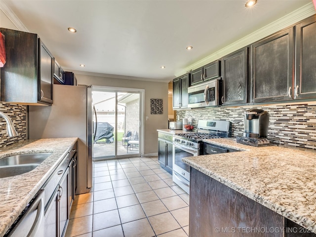 1304 W Kent St, Broken Arrow, OK 74012 - kitchen with appliances with stainless steel finishes, ornamental molding, decorative backsplash, light tile patterned floors, and light stone countertops