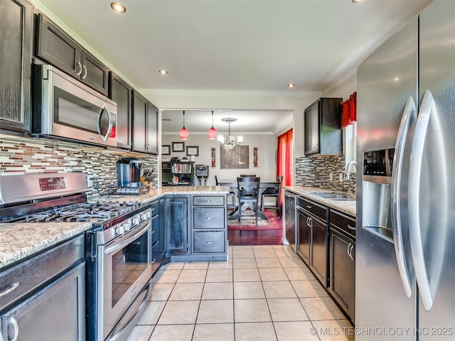 1304 W Kent St, Broken Arrow, OK 74012 - kitchen featuring appliances with stainless steel finishes, a chandelier, crown molding, tasteful backsplash, and light tile patterned floors