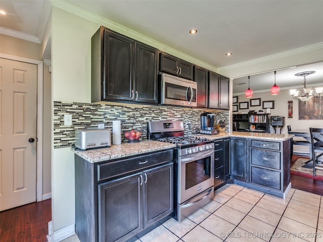 1304 W Kent St, Broken Arrow, OK 74012 - kitchen featuring appliances with stainless steel finishes, a peninsula, decorative backsplash, a chandelier, and crown molding