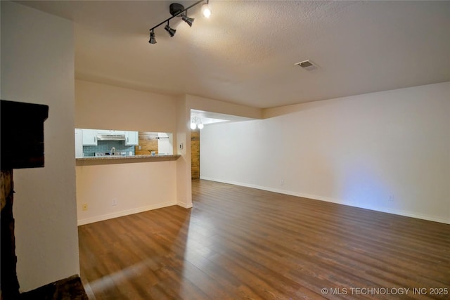 6370 S 80th E Ave Unit E, Tulsa, OK 74133 - unfurnished living room with dark wood-style floors and track lighting