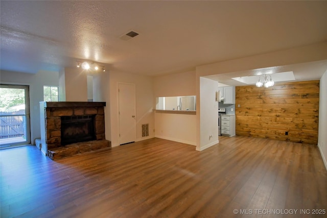6370 S 80th E Ave Unit E, Tulsa, OK 74133 - unfurnished living room with wood finished floors and a fireplace