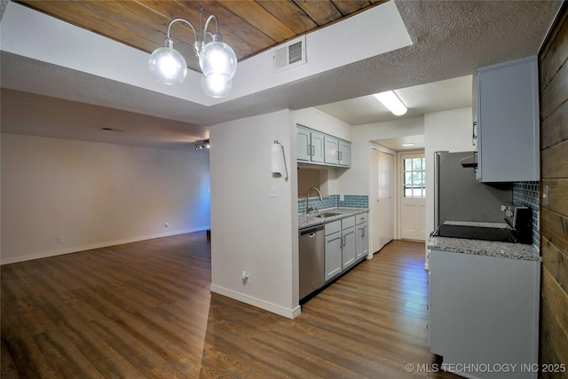 6370 S 80th E Ave Unit E, Tulsa, OK 74133 - kitchen featuring stainless steel appliances, dark wood finished floors, decorative backsplash, light countertops, and open floor plan
