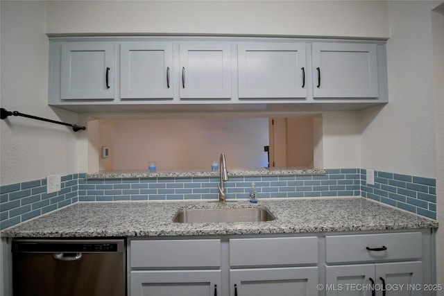 6370 S 80th E Ave Unit E, Tulsa, OK 74133 - kitchen featuring stainless steel dishwasher, tasteful backsplash, light stone countertops, and gray cabinets