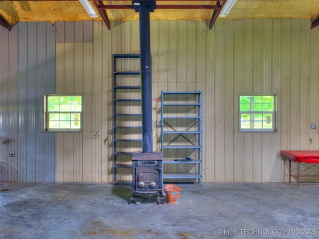 30833 S 4190th Rd, Inola, OK 74006 - miscellaneous room featuring healthy amount of natural light, concrete flooring, and a wood stove