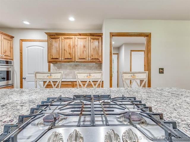 30833 S 4190th Rd, Inola, OK 74006 - kitchen with stainless steel appliances, light stone counters, backsplash, and recessed lighting