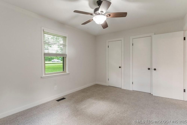 17069 S 87th Ave E, Bixby, OK 74008 - unfurnished bedroom with carpet, two closets, and a ceiling fan