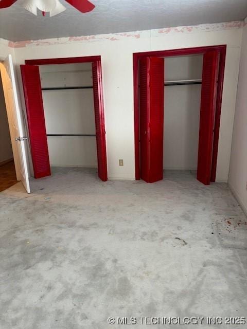 260 N 260th Rd, Mounds, OK 74047 - unfurnished bedroom featuring two closets, carpet, and ceiling fan