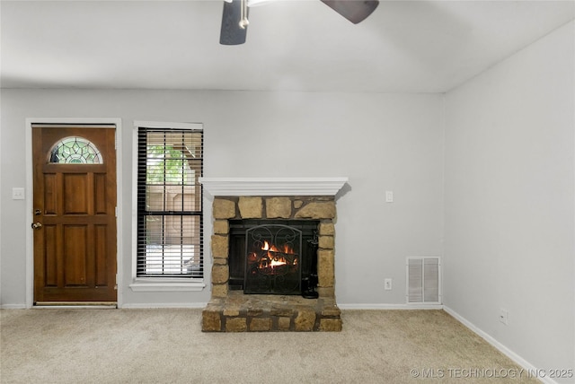 6364 S 80th E Ave Unit 34E, Tulsa, OK 74133 - unfurnished living room featuring ceiling fan, a stone fireplace, and carpet floors