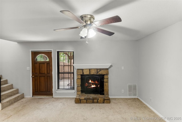 6364 S 80th E Ave Unit 34E, Tulsa, OK 74133 - unfurnished living room with a stone fireplace, carpet, a ceiling fan, and stairs