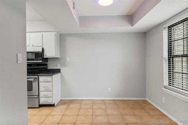 6364 S 80th E Ave Unit 34E, Tulsa, OK 74133 - kitchen featuring black microwave, stainless steel range with electric stovetop, white cabinetry, dark countertops, and healthy amount of natural light