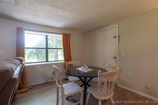 9730 S 4050th Rd, Talala, OK 74080 - dining room with light wood finished floors and a textured ceiling