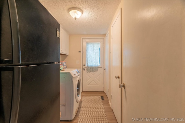 9730 S 4050th Rd, Talala, OK 74080 - laundry room featuring light wood finished floors, a textured ceiling, and washer and clothes dryer