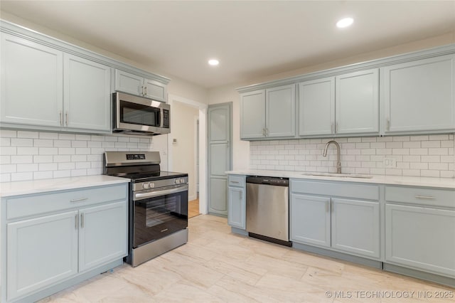 4138 E 36th St, Tulsa, OK 74135 - kitchen featuring stainless steel appliances, gray cabinetry, light countertops, tasteful backsplash, and recessed lighting
