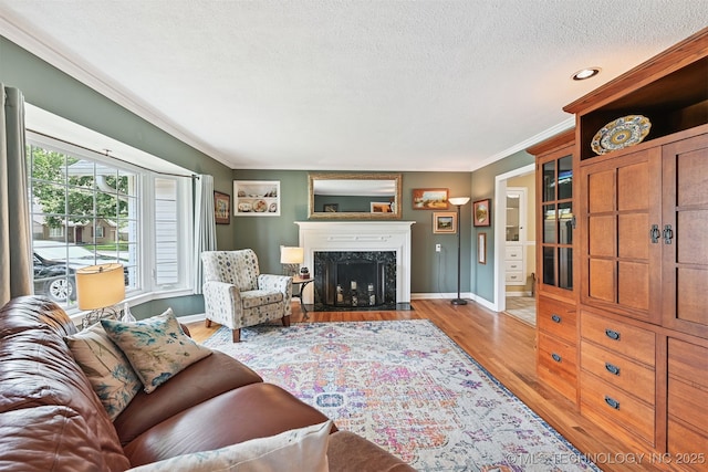 1347 E 37th St, Tulsa, OK 74105 - living area featuring ornamental molding, a textured ceiling, wood finished floors, a fireplace, and recessed lighting