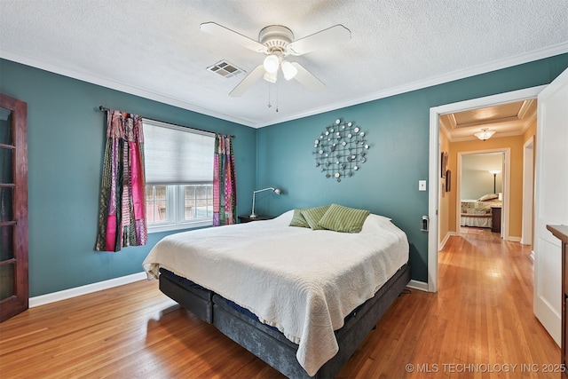 1347 E 37th St, Tulsa, OK 74105 - bedroom with wood finished floors, attic access, crown molding, a textured ceiling, and ceiling fan