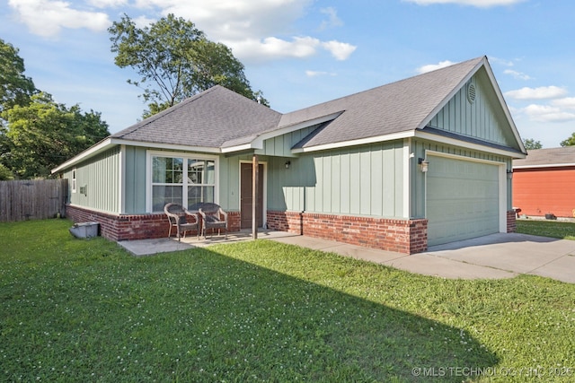 311 E 4th St, Skiatook, OK 74070 - view of front of property featuring brick siding, roof with shingles, board and batten siding, driveway, and a garage