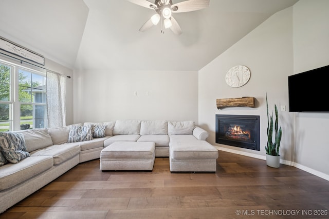 311 E 4th St, Skiatook, OK 74070 - living room featuring a ceiling fan, wood finished floors, a glass covered fireplace, and high vaulted ceiling
