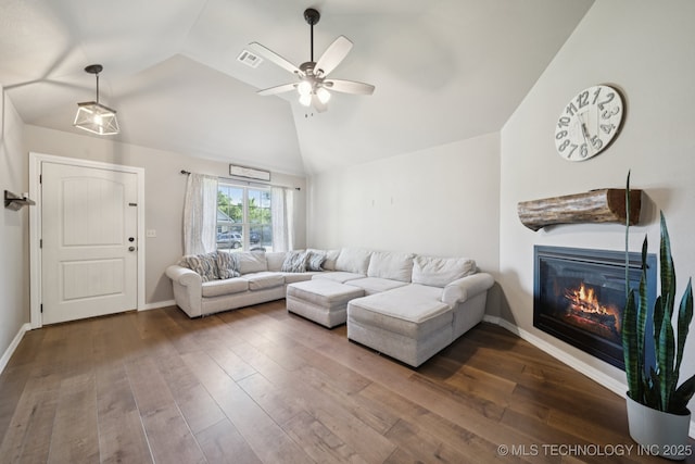 311 E 4th St, Skiatook, OK 74070 - living room with lofted ceiling, ceiling fan, a glass covered fireplace, and dark wood-style floors