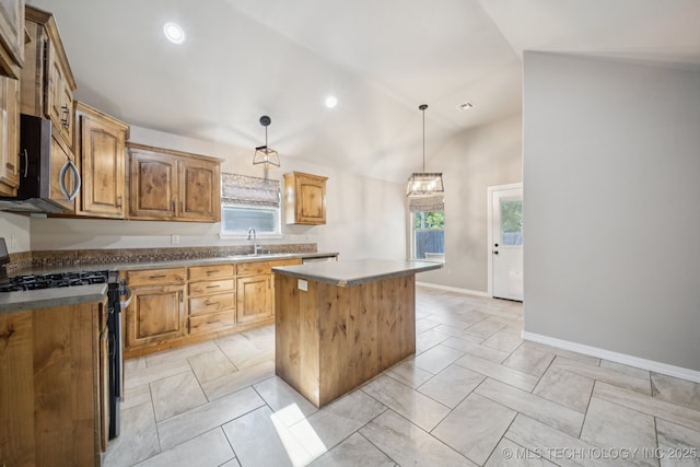 311 E 4th St, Skiatook, OK 74070 - kitchen with appliances with stainless steel finishes, a kitchen island, decorative light fixtures, lofted ceiling, and light marble finish floors