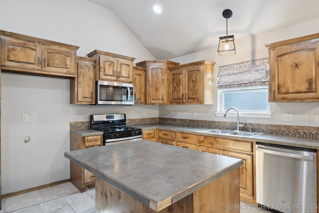 311 E 4th St, Skiatook, OK 74070 - kitchen with appliances with stainless steel finishes, vaulted ceiling, dark countertops, pendant lighting, and brown cabinets