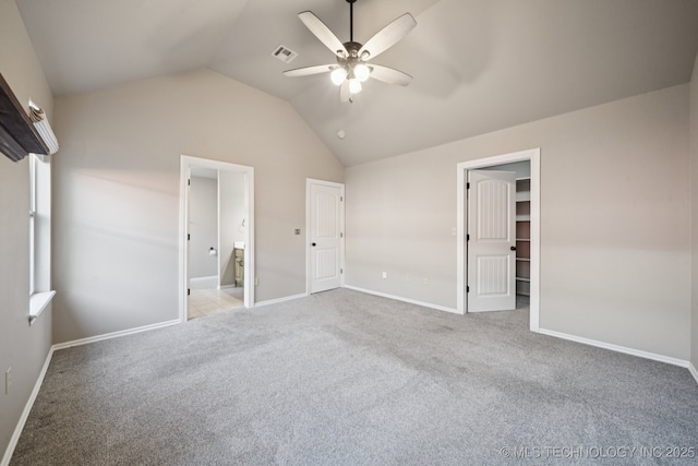 311 E 4th St, Skiatook, OK 74070 - unfurnished bedroom featuring carpet flooring, vaulted ceiling, a ceiling fan, ensuite bathroom, and a spacious closet