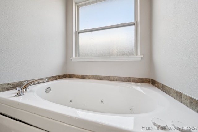 311 E 4th St, Skiatook, OK 74070 - full bath featuring a whirlpool tub and a textured wall