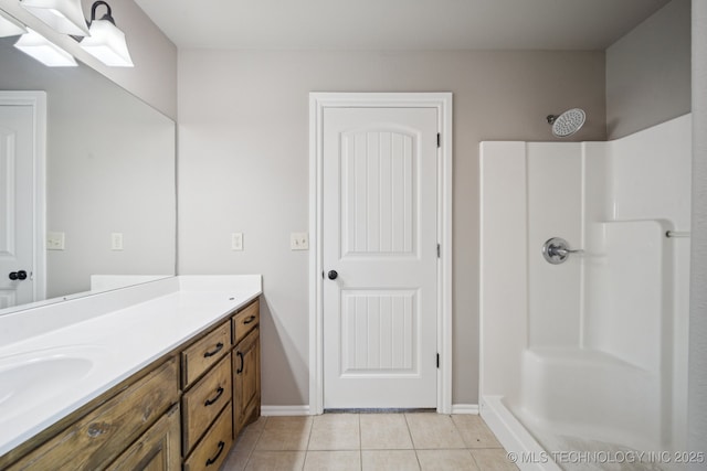 311 E 4th St, Skiatook, OK 74070 - bathroom featuring a shower, tile patterned floors, and vanity