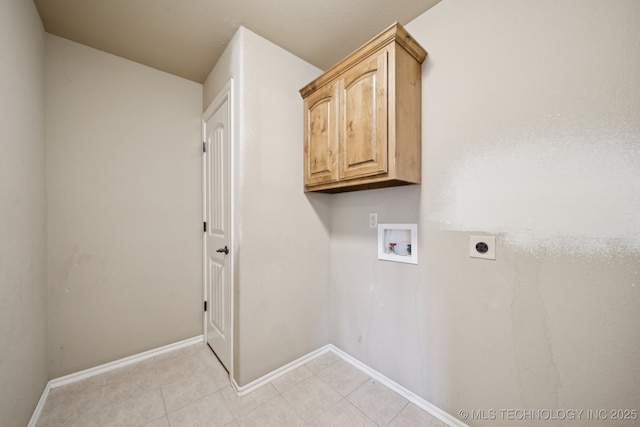 311 E 4th St, Skiatook, OK 74070 - laundry area featuring electric dryer hookup, washer hookup, light tile patterned floors, and cabinet space
