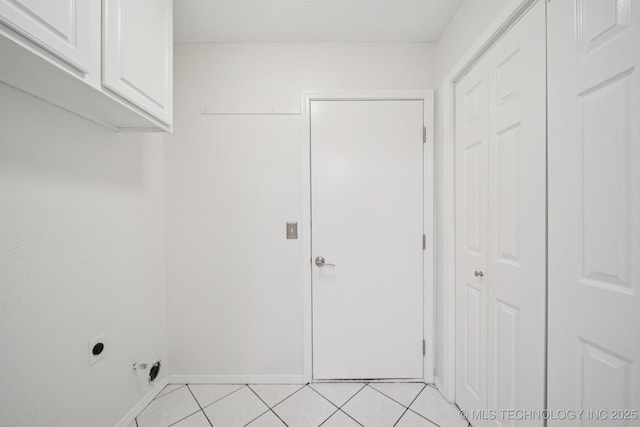 13111 E 80th St N, Owasso, OK 74055 - laundry area featuring cabinet space, hookup for an electric dryer, and light tile patterned flooring