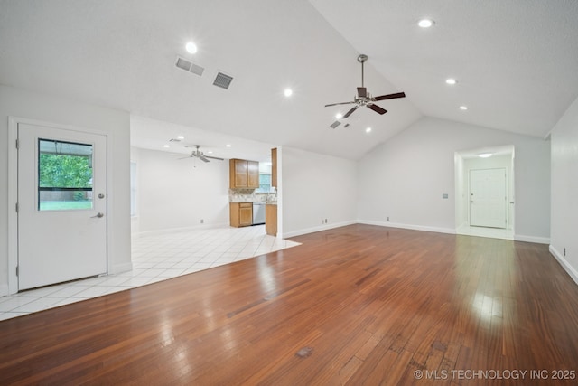 13111 E 80th St N, Owasso, OK 74055 - unfurnished living room featuring a ceiling fan, vaulted ceiling, light wood-type flooring, and recessed lighting