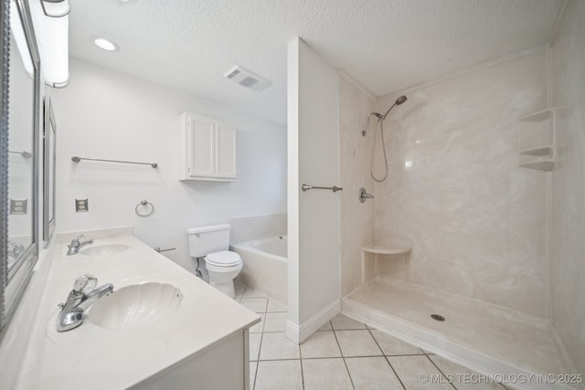 13111 E 80th St N, Owasso, OK 74055 - bathroom with tile patterned floors, double vanity, a textured ceiling, a shower, and a bath