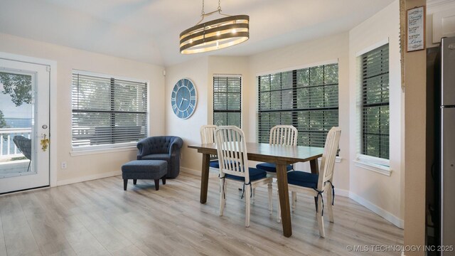 3942 Elm Dr, Kingston, OK 73439 - dining area featuring light wood-style floors, plenty of natural light, and a chandelier