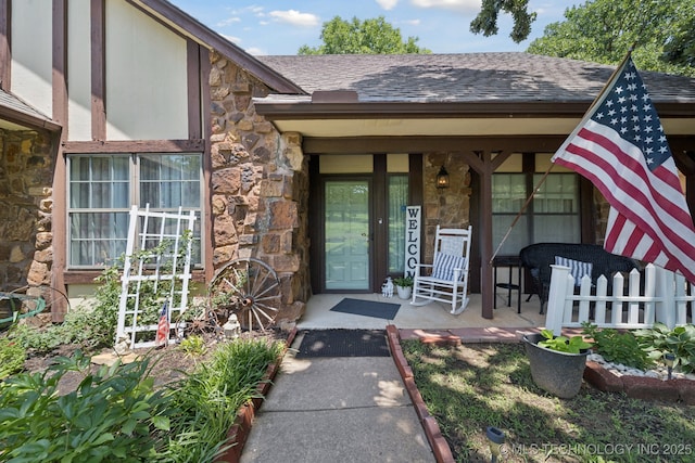 2519 W 53rd St, Tulsa, OK 74107 - entrance to property with stone siding, covered porch, and a shingled roof