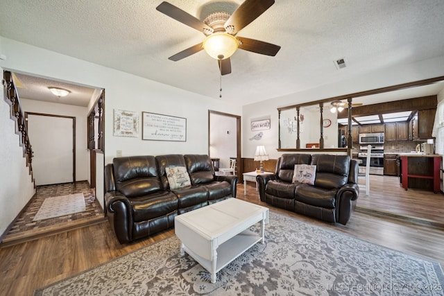 2519 W 53rd St, Tulsa, OK 74107 - living area with wood finished floors, ceiling fan, and a textured ceiling