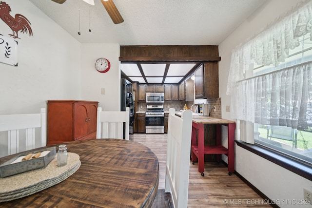 2519 W 53rd St, Tulsa, OK 74107 - dining space with light wood finished floors, a textured ceiling, and a ceiling fan