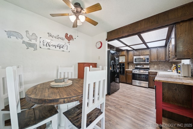 2519 W 53rd St, Tulsa, OK 74107 - dining room with a ceiling fan and light wood-type flooring