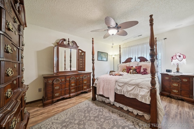 2519 W 53rd St, Tulsa, OK 74107 - bedroom with wood finished floors, a textured ceiling, and ceiling fan